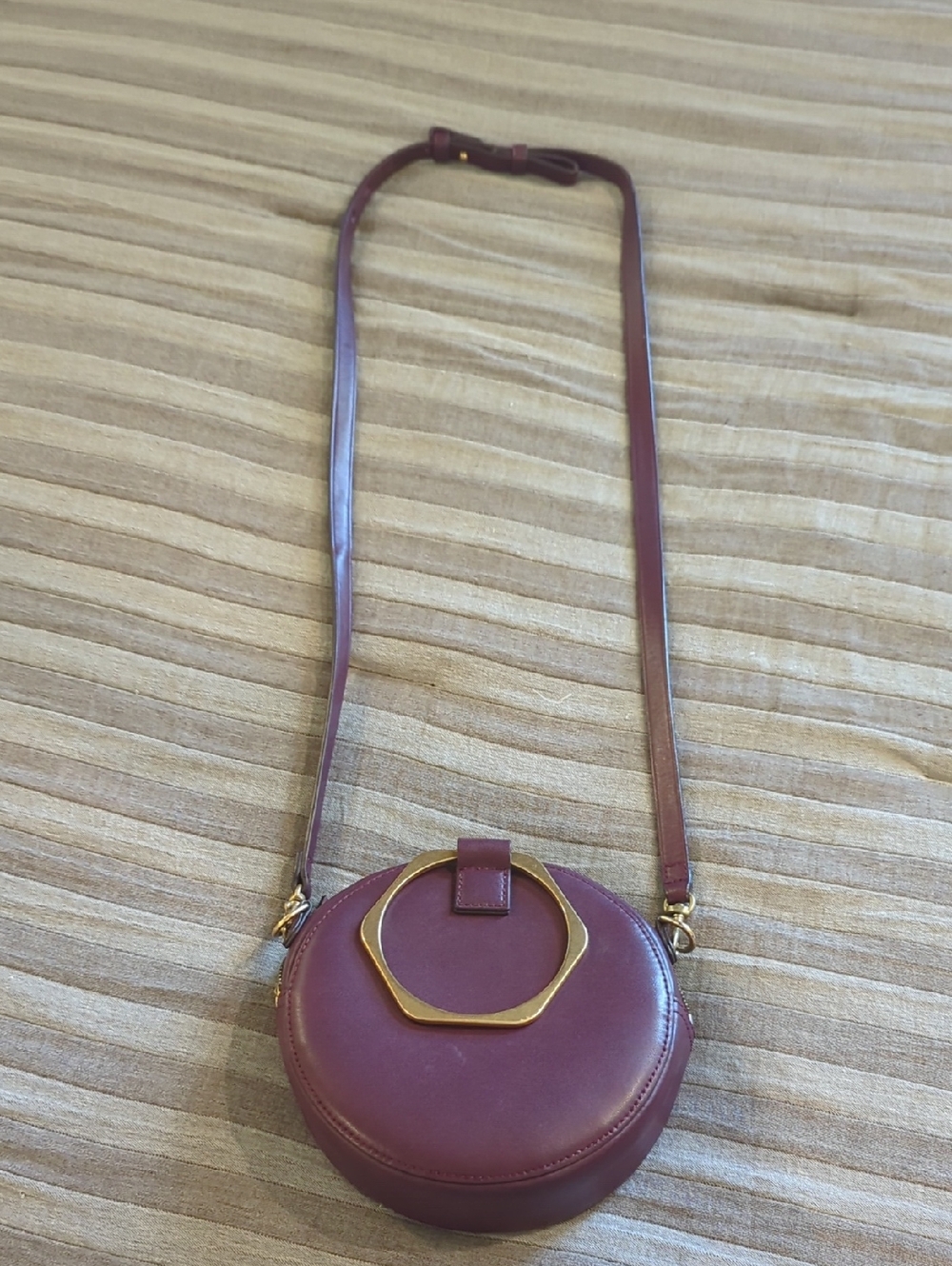 Thacker Round Crossbody Bag in Plum with Gold Accent
